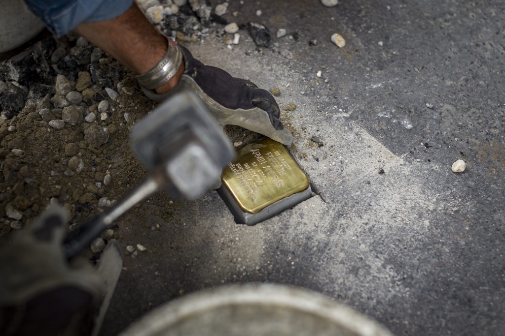 Budapest, 2015. július 20. Gunter Demnig német képzõmûvész botlatókövet helyez el az Egy kõ, egy név, egy emlék - Stolpersteine / Botlatókövek 2015 projekt keretében a holokauszt zsidó és roma áldozatainak emlékére a Várfok utcában 2015. július 20-án. A mûvész Budapesten, Szegeden és Nagykanizsán 56 helyszínen 77 botlatókövet helyez el. MTI Fotó: Szigetváry Zsolt