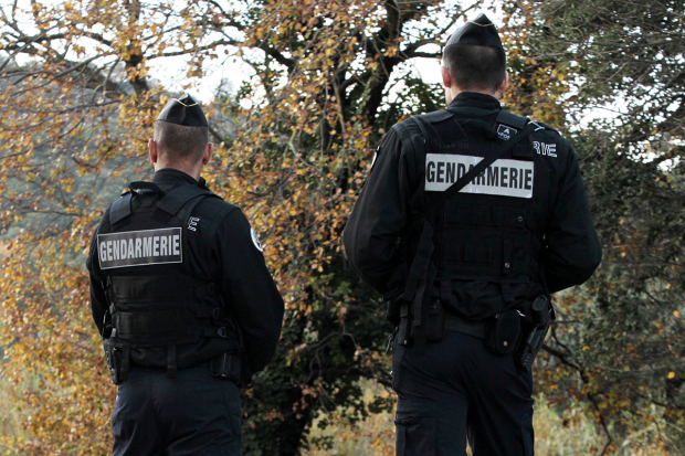 French gendarmes patrol on the road, on December 8, 2015 in La Mole, near Saint-Tropez, southeastern France, as they search for the man who injured a French police officer and killed another in Cavalaire the day before. The alleged suspect of the shooting is still sought. / AFP / Jean-Christophe MAGNENET (Photo credit should read JEAN-CHRISTOPHE MAGNENET/AFP/Getty Images)
